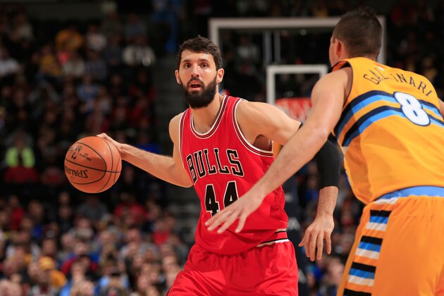 DENVER, CO - NOVEMBER 25:  Nikola Mirotic #44 of the Chicago Bulls controls the ball against Danilo Gallinari #8 of the Denver Nuggets at Pepsi Center on November 25, 2014 in Denver, Colorado. The Nuggets defeated the Bulls 114-109. NOTE TO USER: User expressly acknowledges and agrees that, by downloading and or using this photograph, User is consenting to the terms and conditions of the Getty Images License Agreement.  (Photo by Doug Pensinger/Getty Images)