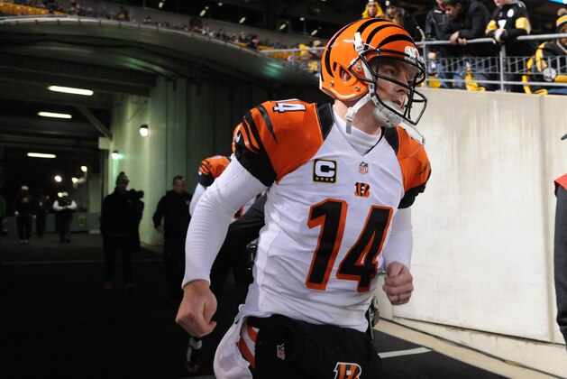 Cincinnati Bengals quarterback Andy Dalton (14) takes the field to warm up before an NFL football game against the Pittsburgh Steelers, Sunday, Dec. 28, 2014 in Pittsburgh. (AP Photo/Don Wright)