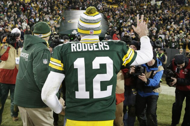 Green Bay Packers' Aaron Rodgers waves to the crowd as he leaves the field after an NFL football game against the Detroit Lions Sunday, Dec. 28, 2014, in Green Bay, Wis. The Packers won 30-20. (AP Photo/Jim Slosiarek)