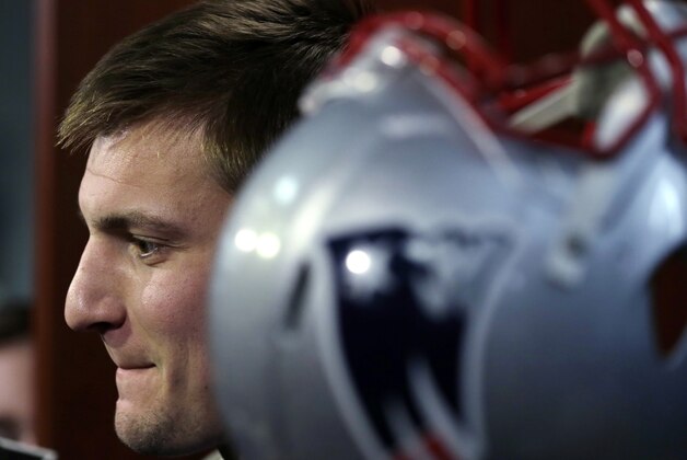 New England Patriots tight end Rob Gronkowski answers a reporter's question during a media availability in the locker room before NFL football practice in Foxborough, Mass., Tuesday, Dec. 23, 2014. (AP Photo/Charles Krupa)