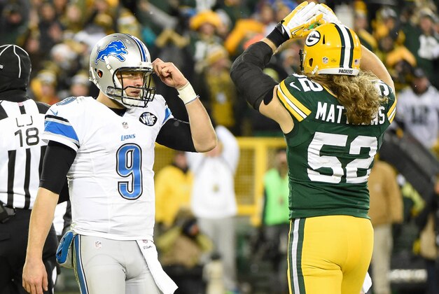 Dec 28, 2014; Green Bay, WI, USA;  Detroit Lions quarterback Matthew Stafford (9) and Green Bay Packers linebacker Clay Matthews (52) react after officials ruled intentional grounding in the endzone resulting in a safety in the fourth quarter at Lambeau Field. Mandatory Credit: Benny Sieu-USA TODAY Sports
