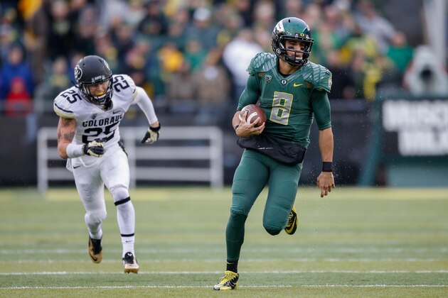 EUGENE, OR - NOVEMBER 22:  Quarterback Marcus Mariota #8 of the Oregon Ducks rushes for a touchdown in the first quarter against the Colorado Buffaloes at Autzen Stadium on November 22, 2014 in Eugene, Oregon. The Ducks defeated the Buffaloes 44-10.  (Photo by Otto Greule Jr/Getty Images)