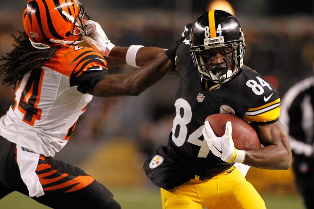 PITTSBURGH, PA - DECEMBER 28:  Antonio Brown #84 of the Pittsburgh Steelers stiff arms Adam Jones #24 of the Cincinnati Bengals during the second quarter at Heinz Field on December 28, 2014 in Pittsburgh, Pennsylvania.  (Photo by Justin K. Aller/Getty Images)