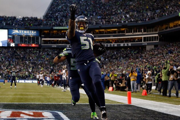 SEATTLE, WA - DECEMBER 28: Outside linebacker Bruce Irvin #51 of the Seattle Seahawks celebrates after running an interception back 49 yards for a touchdown during the fourth quarter of the game against the St. Louis Rams at CenturyLink Field on December 28, 2014 in Seattle, Washington. (Photo by Otto Greule Jr/Getty Images)