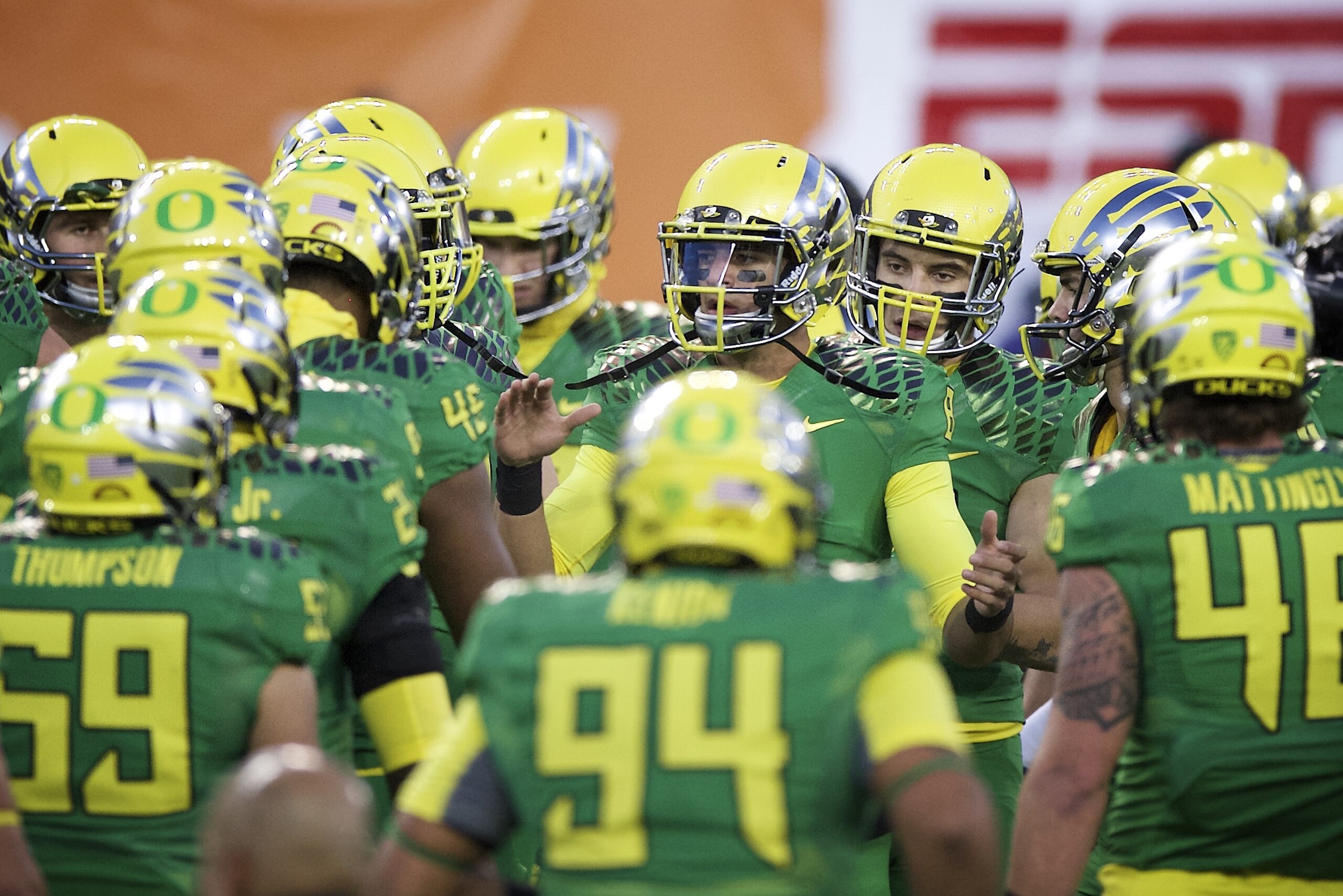 Oregon quarterback Marcus Mariota (8) leads the Ducks through warm up drills before an NCAA college football game against Oregon State in Corvallis, Or., Saturday, Nov. 15, 2014. (AP Photo/Troy Wayrynen)