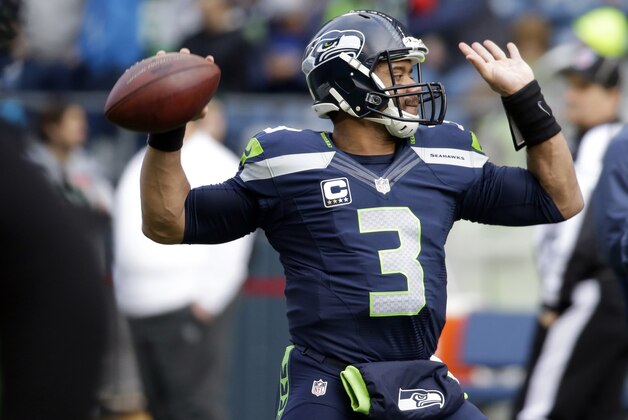 Seattle Seahawks quarterback Russell Wilson passes during warmups before an NFL football game against the St. Louis Rams, Sunday, Dec. 28, 2014, in Seattle. (AP Photo/Elaine Thompson)