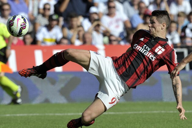 AC Milan forward Fernando Torres of Spain reachses for the ball during a Serie A soccer match between Cesena and AC Milan at Cesena's Manuzzi stadium, Italy, Sunday, Sept. 28, 2014. (AP Photo/Marco Vasini)