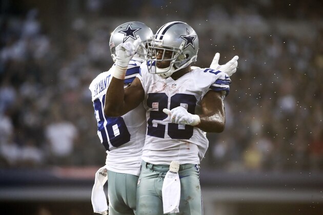 Dallas Cowboys' Dez Bryant (88) and DeMarco Murray (29) celebrate Murray's touchdown run against the New York Giants during the second half of an NFL football game, Sunday, Oct. 19, 2014, in Arlington, Texas. (AP Photo/Brandon Wade)