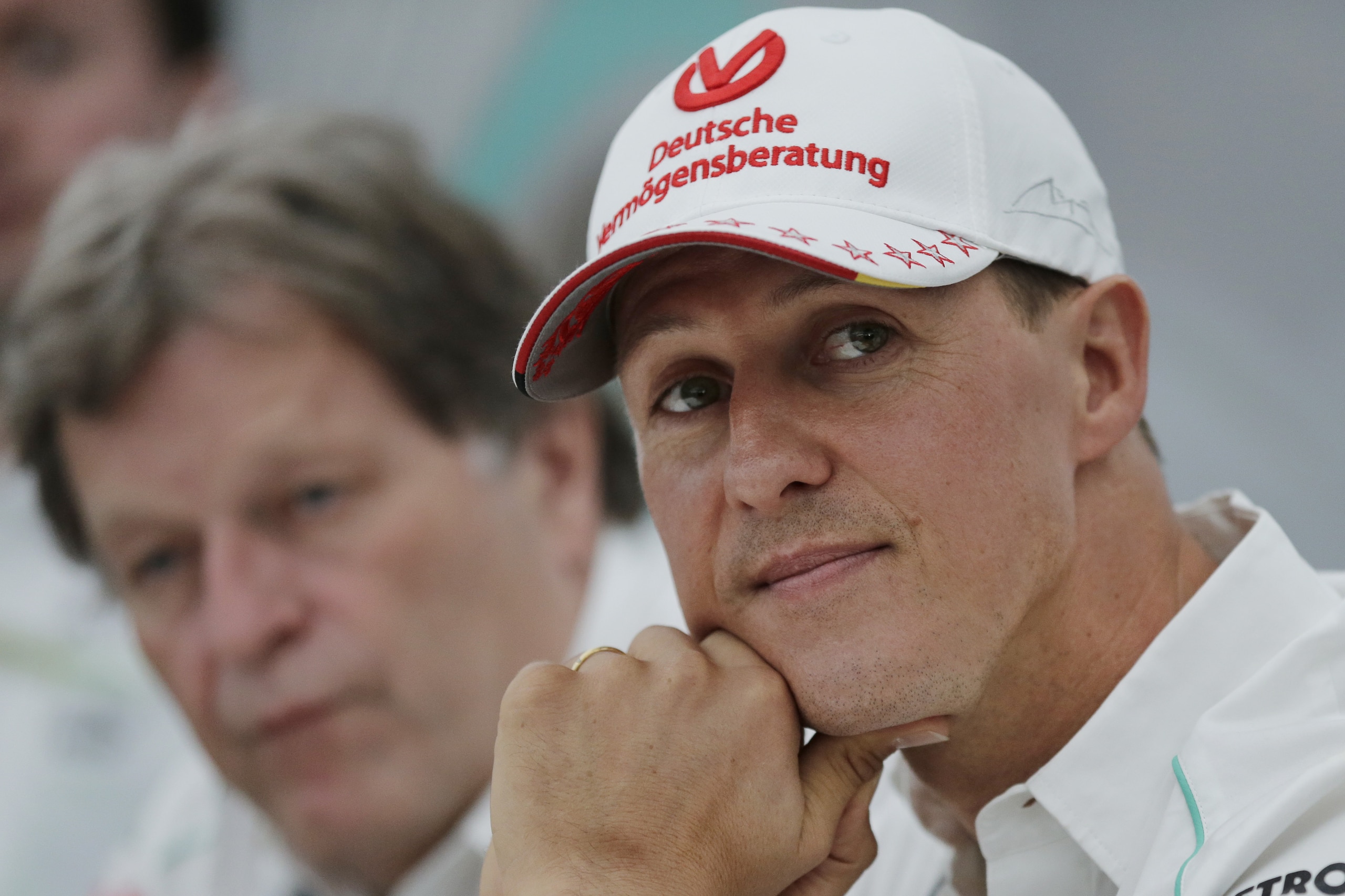 FILE - In this Thursday, Oct. 4, 2012 file photo, former Mercedes F1 driver Michael Schumacher of Germany pauses during a news conference to announce his retirement from Formula One at the end of  2012  in Suzuka, Japan.  Former Formula One world champion Michael Schumacher has left hospital to continue his recovery at home, his manager said Tuesday. The seven-time champion suffered a serious head injury while skiing in France in December, resulting in him being put in a coma. (AP Photo/Shizuo Kambayashi, File)