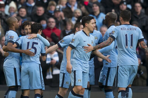 Manchester City's David Silva, second left, celebrates with teammates after scoring against Burnley during the English Premier League soccer match between Manchester City and Burnley at the Etihad Stadium, Manchester, England, Sunday Dec. 28, 2014. (AP Photo/Jon Super)