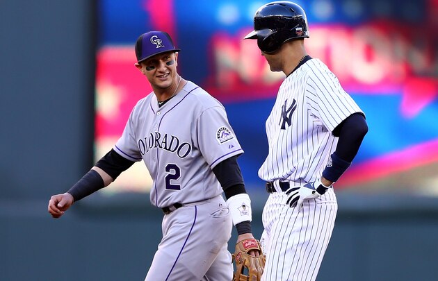 Jul 13, 2014; Denver, CO, USA; Colorado Rockies shortstop Troy Tulowitzki (2) hits a double during the ninth inning against the Minnesota Twins at Coors Field. The Twins won 13-5.  Mandatory Credit: Chris Humphreys-USA TODAY Sports