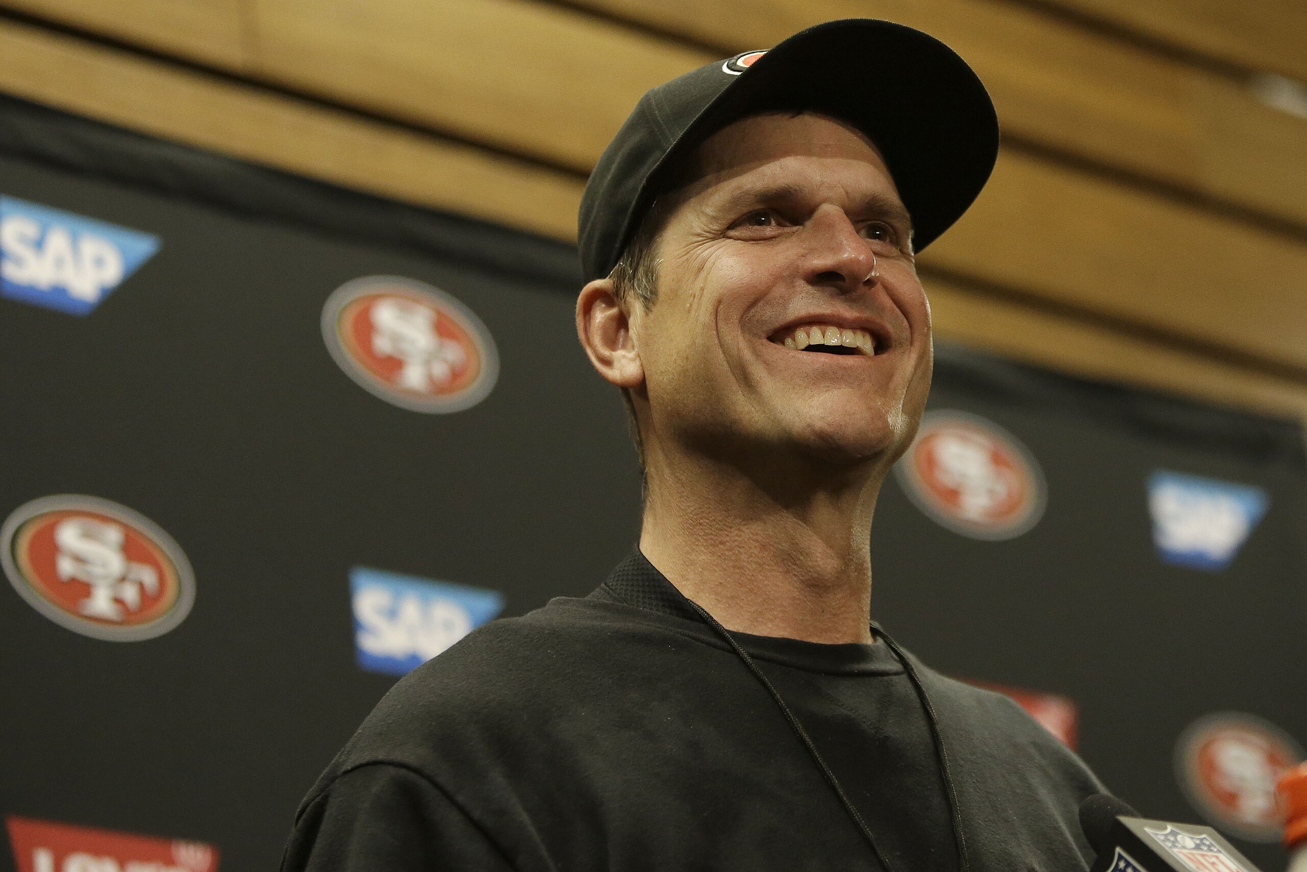 San Francisco 49ers head coach Jim Harbaugh speaks at a news conference after an NFL football game against the Arizona Cardinals in Santa Clara, Calif., Sunday, Dec. 28, 2014. (AP Photo/Marcio Jose Sanchez) San Francisco 49ers head coach Jim Harbaugh speaks at a news conference after an NFL football game against the Arizona Cardinals in Santa Clara, Calif., Sunday, Dec. 28, 2014. (AP Photo/Marcio Jose Sanchez)
