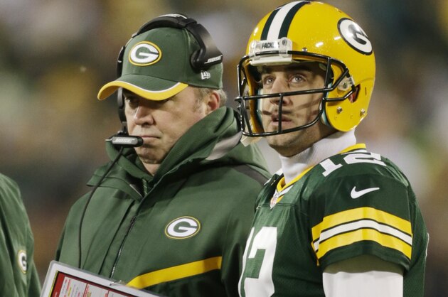 Green Bay Packers head coach Mike McCarthy talks to Aaron Rodgers during the first half of an NFL football game against the Detroit Lions Sunday, Dec. 28, 2014, in Green Bay, Wis. (AP Photo/Jim Slosiarek)