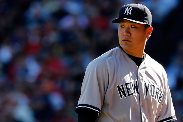 BOSTON, MA - SEPTEMBER 27:  Masahiro Tanaka #19 of the New York Yankees looks on against the Boston Red Sox in the second inning during a game at Fenway Park on September 27, 2014 in Boston, Massachusetts.  (Photo by Jim Rogash/Getty Images)