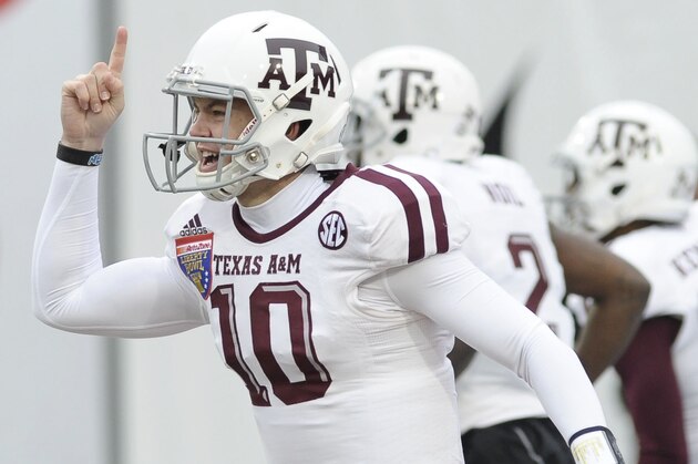 Dec 29, 2014; Memphis, TN, USA; Texas A&M Aggies quarterback Kyle Allen (10) celebrates after scoring a touchdown during the game against the West Virginia Mountaineers in the 2014 Liberty Bowl at Liberty Bowl Memorial Stadium. Mandatory Credit: Justin Ford-USA TODAY Sports