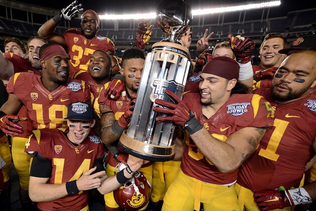 SAN DIEGO, CA -  DECEMBER 27:  Members of the USC Trojans celebrate their 45-42 win over the Nebraska Cornhuskers during the National University Holiday Bowl on December 27, 2014 at Qualcomm Stadium in San Diego, California. (Photo by Donald Miralle/Getty Images)