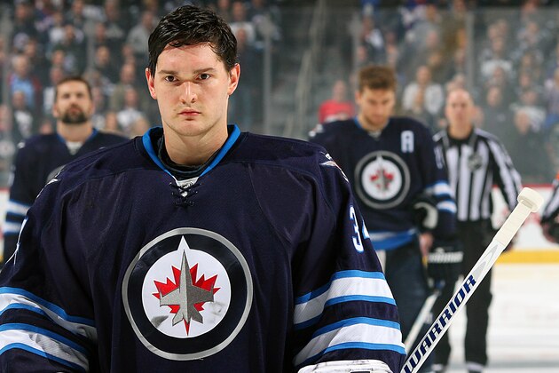WINNIPEG, CANADA - DECEMBER 13: Goaltender Michael Hutchinson #34 of the Winnipeg Jets looks on during the singing of the National anthems prior to puck drop against the Anaheim Ducks on December 13, 2014 at the MTS Centre in Winnipeg, Manitoba, Canada. (Photo by Jonathan Kozub/NHLI via Getty Images)
