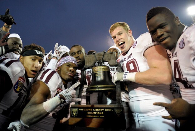 Dec 29, 2014; Memphis, TN, USA; Texas A&M Aggies players celebrate after the game against the West Virginia Mountaineers in the 2014 Liberty Bowl at Liberty Bowl Memorial Stadium. Texas A&M Aggies beat West Virginia Mountaineers 45 - 37. Mandatory Credit: Justin Ford-USA TODAY Sports