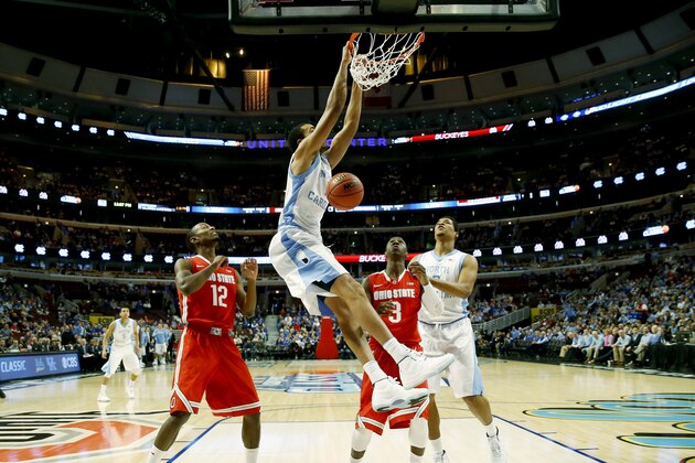 North Carolina forward Brice Johnson (11) dunks as forward Kennedy Meeks (3) and Ohio State forward Sam Thompson (12), guard Shannon Scott (3) look on during the first half of an NCAA college basketball game in CBS Sports Classic on Saturday, Dec. 20, 2014, in Chicago. (AP Photo/Charles Rex Arbogast)