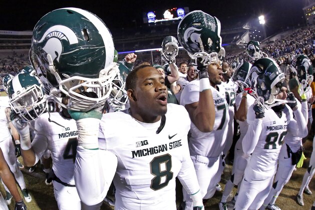 Michigan State defensive lineman Lawrence Thomas (8) joins his teammates in singing the Michigan State alma mater after a 34-10 win over Penn State  in an NCAA college football game in State College, Pa., Saturday, Nov. 29, 2014. (AP Photo/Gene J. Puskar)