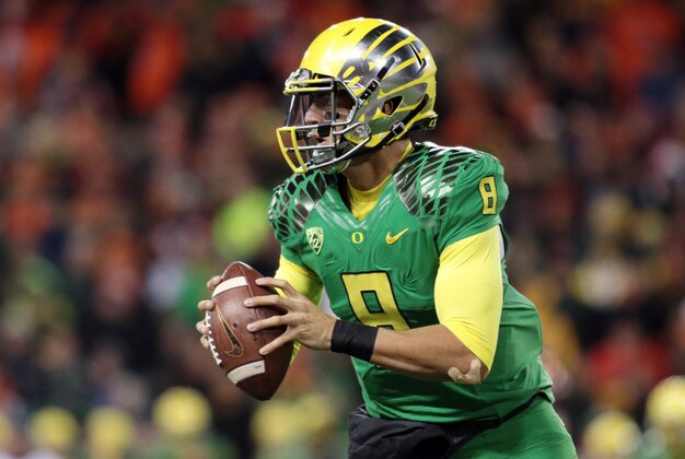 Nov 29, 2014; Corvallis, OR, USA; Oregon Ducks quarterback Marcus Mariota (8) runs the ball against the Oregon State Beavers at Reser Stadium. Mandatory Credit: Scott Olmos-USA TODAY Sports