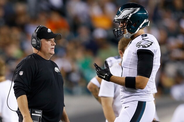 Philadelphia Eagles head coach Chip Kelly, left, talks with Nick Foles during the first half of an NFL preseason football game against the Pittsburgh Steelers, Thursday, Aug. 21, 2014, in Philadelphia. (AP Photo/Michael Perez)