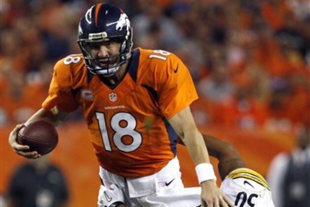 Denver Broncos quarterback Peyton Manning (18) is wrapped up by Pittsburgh Steelers linebacker Larry Foote (50) during the second quarter of an NFL football game, Sunday, Sept. 9, 2012, in Denver. (AP Photo/David Zalubowski)