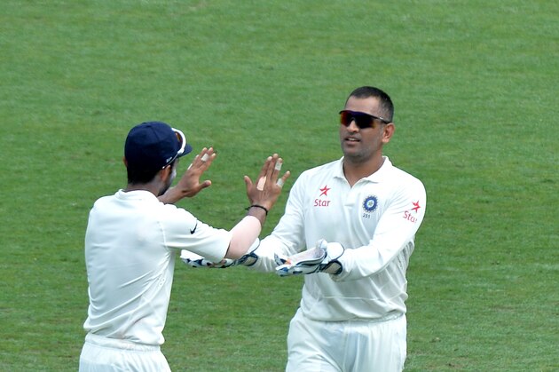BRISBANE, AUSTRALIA - DECEMBER 18: Mahendra Singh Dhoni of India celebrates after taking a catch to dismiss Chris Rogers of Australia during day two of the 2nd Test match between Australia and India at The Gabba on December 18, 2014 in Brisbane, Australia.  (Photo by Bradley Kanaris/Getty Images)
