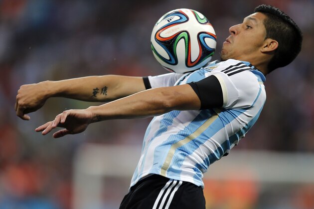 Argentina's Enzo Perez controls a ball during the World Cup semifinal soccer match between the Netherlands and Argentina at the Itaquerao Stadium in Sao Paulo, Brazil, Wednesday, July 9, 2014. (AP Photo/Frank Augstein)