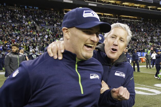 Seattle Seahawks head coach Pete Carroll, right, celebrates with defensive coordinator Dan Quinn, left, after they defeated the St. Louis Rams 20-6 in an NFL football game, Sunday, Dec. 28, 2014, in Seattle. (AP Photo/Scott Eklund)