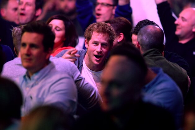 LONDON, ENGLAND - DECEMBER 29: Prince Harry enjoys the darts match between Stephen Bunting of England and James Wade of England with friends during the William Hill PDC World Darts Championships on Day Nine at Alexandra Palace on December 29, 2014 in London, England. (Photo by Charlie Crowhurst/Getty Images)
