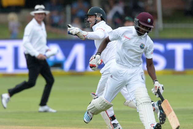 PORT ELIZABETH, SOUTH AFRICA - DECEMBER 29:  Kenroy Peters gets run out by Dale Steyn and AB de Villiers during day 4 of the 2nd Test match between South Africa and West Indies at St. Georges Park on December 29, 2014 in Port Elizabeth, South Africa. (Photo by Duif du Toit/Gallo Images/Getty Images)