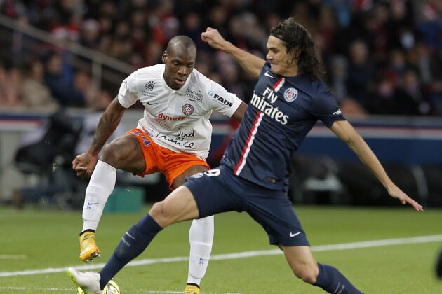 Montpellier’s Bryan Dabo, left, vies for the ball with Paris Saint Germain's Edinson Cavani, during the League One soccer match between Paris Saint Germain and Montpellier,  at Parc des Princes stadium, in Paris, Saturday, Dec. 20, 2014. (AP Photo/Francois Mori)
