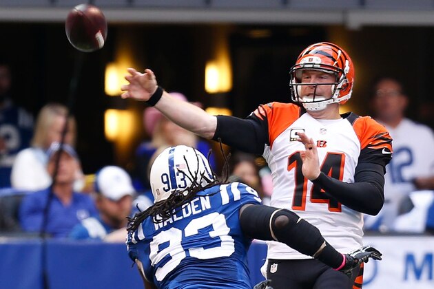 INDIANAPOLIS, IN - OCTOBER 19:  Andy Dalton #14 of the Cincinnati Bengals throws the ball while being pressured by Erik Walden #93 of the Indianapolis Colts during the first quarter on October 19, 2014 at Lucas Oil Stadium on October 19, 2014 in Indianapolis, Indiana. (Photo by Kirk Irwin/Getty Images)