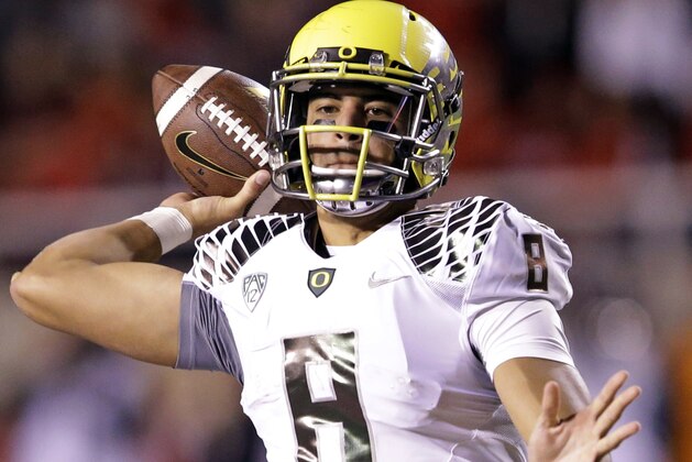 FILE - In this Nov. 8, 2014, file photo, Oregon quarterback Marcus Mariota (8) passes the ball in the second half during an NCAA college football game against Utah in Salt Lake City. When Mariota and second-seeded Oregon face Jameis Winston and third-seeded Florida State in the the College Football Playoff semifinal at the Rose Bowl on Jan. 1 it will be the third time Heisman Trophy winners have met in a postseason game. (AP Photo/Rick Bowmer, File)