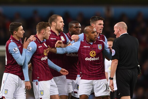 BIRMINGHAM, ENGLAND - DECEMBER 20:  Aston Villa players surround Referee Lee Mason after Gabriel Agbonlahor of Aston Villa fouled Ashley Young of Manchester United during the Barclays Premier League match between Aston Villa and Manchester United at Villa Park on December 20, 2014 in Birmingham, England.  (Photo by Michael Regan/Getty Images)