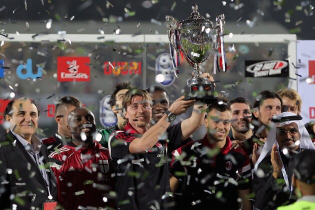 AC Milan's captain, Riccardo Montolivo holds the trophy after they beat Real Madrid in their Dubai Football Challenge match in Dubai, United Arab Emirates, Tuesday, Dec. 30, 2014. (AP Photo/Kamran Jebreili)