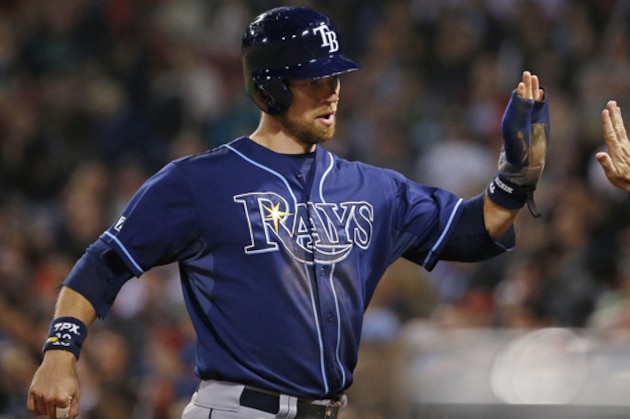 Tampa Bay Rays' Ben Zobrist receives congratulations at the dugout after scoring on a single by David DeJesus in the eighth inning of a baseball game against the Boston Red Sox at Fenway Park in Boston, Tuesday, Sept. 23, 2014. (AP Photo/Elise Amendola)