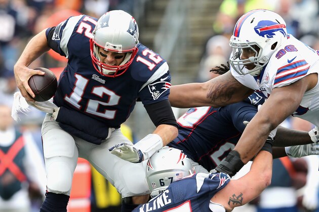 FOXBORO, MA - DECEMBER 28:  Tom Brady #12 of the New England Patriots is tackled by Stefan Charles #96 of the Buffalo Bills during the second quarter at Gillette Stadium on December 28, 2014 in Foxboro, Massachusetts.  (Photo by Jim Rogash/Getty Images)