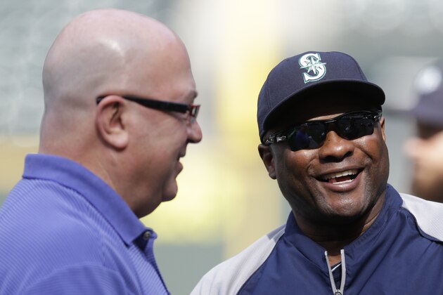 Seattle Mariners manager Lloyd McClendon, right, talks with general manager Jack Zduriencik, left, before a baseball game between the Seattle Mariners and the New York Yankees Wednesday, June 11, 2014 in Seattle. (AP Photo/Ted S. Warren)