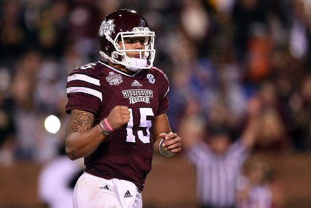 STARKVILLE, MS - NOVEMBER 22:  Dak Prescott #15 of the Mississippi State Bulldogs reacts to a touchdown during the third quarter of a game against the Vanderbilt Commodores at Davis Wade Stadium on November 22, 2014 in Starkville, Mississippi.  (Photo by Stacy Revere/Getty Images)
