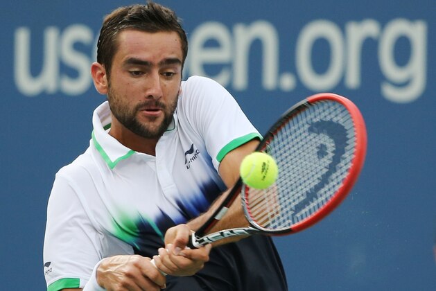 Marin Cilic, of Croatia, returns a shot against Roger Federer, of Switzerland, during the semifinals of the 2014 U.S. Open tennis tournament, Saturday, Sept. 6, 2014, in New York. (AP Photo/Mike Groll)