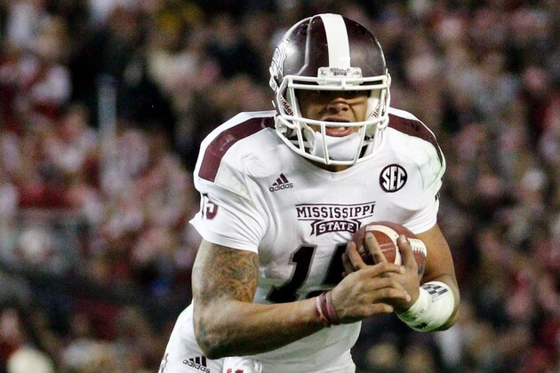 Nov 15, 2014; Tuscaloosa, AL, USA; Mississippi State Bulldogs quarterback Dak Prescott (15) carries the ball against the Alabama Crimson Tide at Bryant-Denny Stadium. Mandatory Credit: Marvin Gentry-USA TODAY Sports