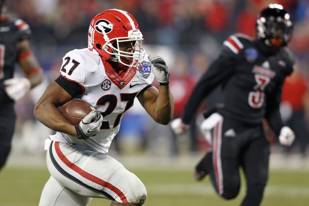 Georgia's Nick Chubb (27) runs for a touchdown against Louisville during the first half of the Belk Bowl NCAA college football game in Charlotte, N.C., Tuesday, Dec. 30, 2014. (AP Photo/Nell Redmond)