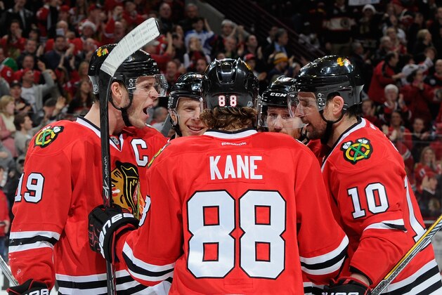 CHICAGO, IL - DECEMBER 14:  Patrick Sharp #10 of the Chicago Blackhawks (right) celebrates with Jonathan Toews #19, Kris Versteeg #23, Patrick Kane #88 and Duncan Keith #2, after scoring against the Calgary Flames in the second period during the NHL game at the United Center on December 14, 2014 in Chicago, Illinois.  (Photo by Bill Smith/NHLI via Getty Images)