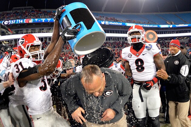 CHARLOTTE, NC - DECEMBER 30:  Chris Conley #31 of the Georgia Bulldogs gives coach Mark Richt a celebratory dunking after a win over the Louisville Cardinals in the Belk Bowl at Bank of America Stadium on December 30, 2014 in Charlotte, North Carolina. Georgia won 37-14.  (Photo by Grant Halverson/Getty Images)