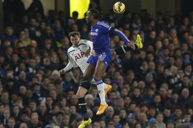Chelsea's Didier Drogba, right heads the ball with Tottenham’s Vlad Chiriches during the English Premier League soccer match between Chelsea and Tottenham Hotspur at Stamford Bridge stadium in London, Wednesday, Dec.  3,  2014. (AP Photo/Alastair Grant)