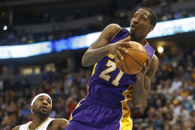 Dec 30, 2014; Denver, CO, USA; Los Angeles Lakers forward Ed Davis (21) rebounds the ball during the first half against the Denver Nuggets at Pepsi Center. Mandatory Credit: Chris Humphreys-USA TODAY Sports