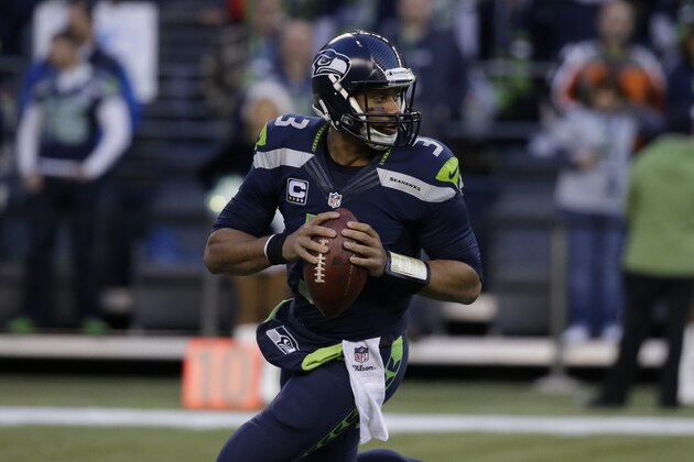 Seattle Seahawks quarterback Russell Wilson looks to pass against the San Francisco 49ers in the second half of an NFL football game, Sunday, Dec. 14, 2014, in Seattle. (AP Photo/Elaine Thompson)