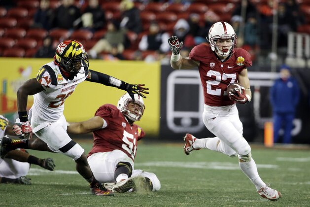 Stanford running back Christian McCaffrey, right, runs past Maryland defensive back Anthony Nixon, left, during the second half of the Foster Farms Bowl NCAA college football game Tuesday, Dec. 30, 2014, in Santa Clara, Calif. (AP Photo/Marcio Jose Sanchez)